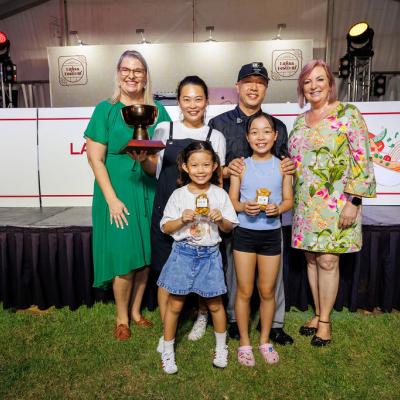 The Makan Stop chefs and their family are posing with their award and their Inspired-By cookies. 