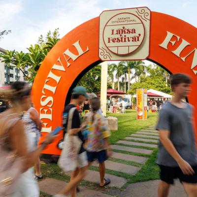 Group of people walking past and underneath the Festival Finale archway