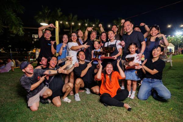 The Kopi Stop team members celebrating their awards by throwing their hands in the air, in front of the Kitchen stage