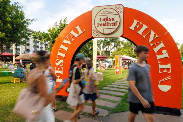 Group of people walking past and underneath the Festival Finale archway