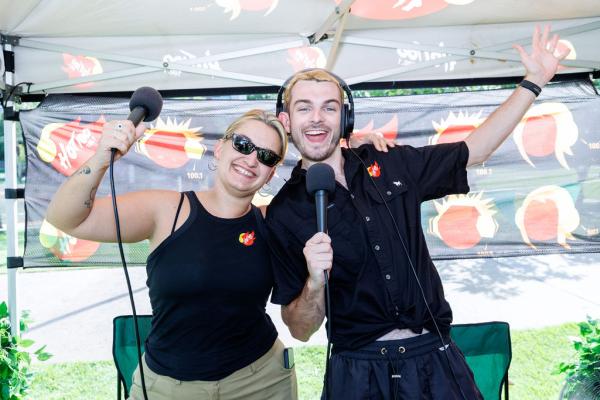 Two radio presenters from HOT100 doing a broadcast